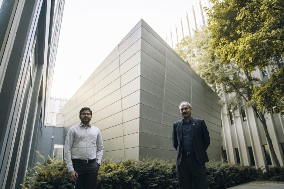 researchers stand in front of building
