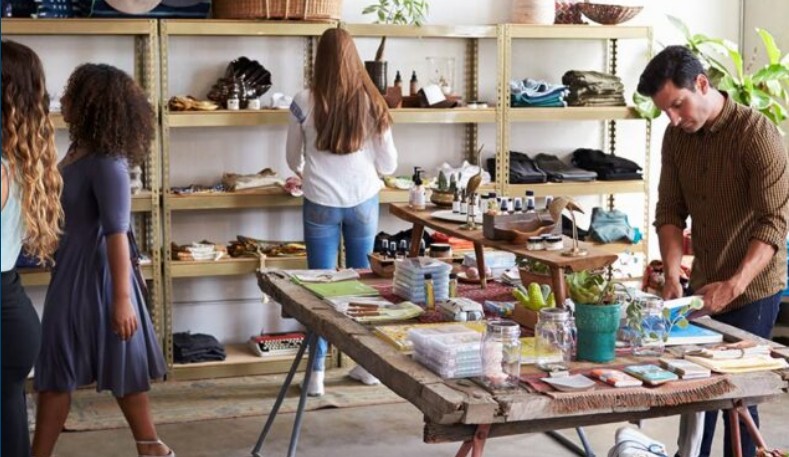 Stock photo of a group of individuals browsing in a boutique retail shop