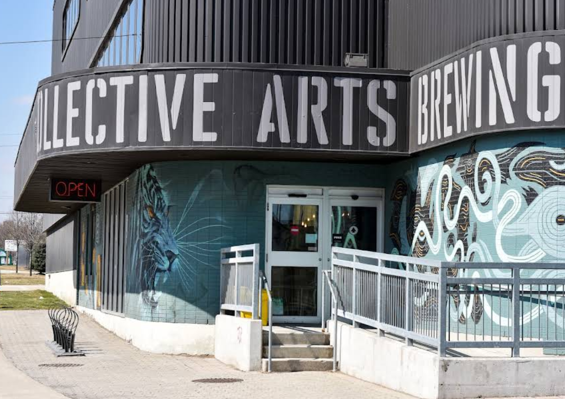 Outside photo of Collective Arts, a brewery and tap room located in Hamilton, Ontario. You can see the entrance with large text that reads: Collective Arts Brewing